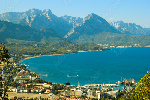 A view of Kemer bay, town, sea and mountains from a hill above. Filtered cross processed image with vintage effect.