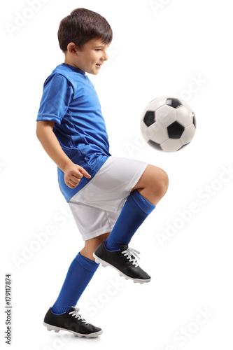Fototapeta Little footballer juggling a football