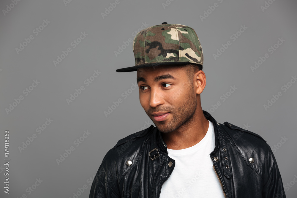 Close-up photo of handsome afro american man in camouflage cap looking aside Close-up photo of handsome afro american man in camouflage cap looking aside