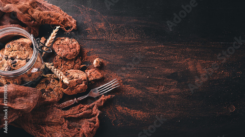 Cookies with chocolate. On a wooden background. Top view. Free space for your text.