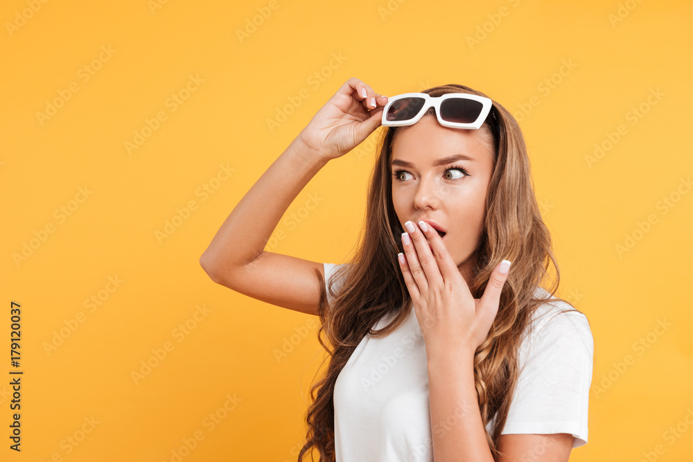 Shocked pretty young woman standing isolated Shocked pretty young woman standing isolated