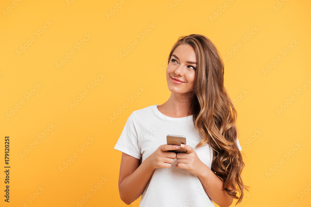Cheerful cute beautiful young woman chatting by mobile phone