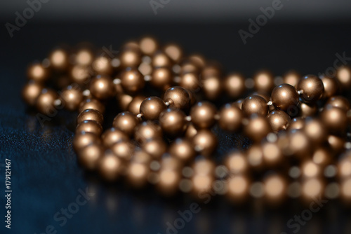 Long brown necklace on a dark background