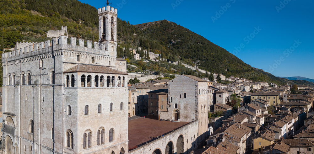 Obraz premium Gubbio, Italy. One of the most beautiful small town in Italy. Drone aerial view of the city center, main square and the historical building called Palazzo dei Consoli