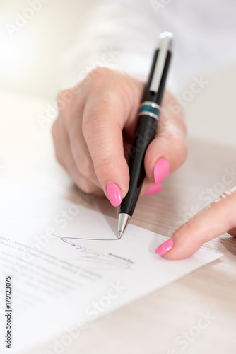 Woman signing a contract