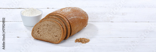 Brot Weizenbrot Weizenmischbrot geschnitten Scheibe Banner Textfreiraum auf Holzplatte photo