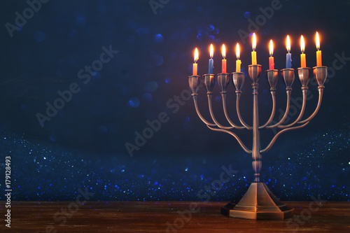 jewish holiday Hanukkah background with menorah (traditional candelabra) and burning candles