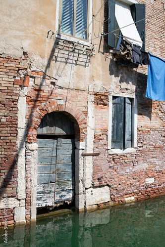 Venice, Wenedig, Wenecja - an old medieval city on water, between canals. View from a sail boat or from the bridges.