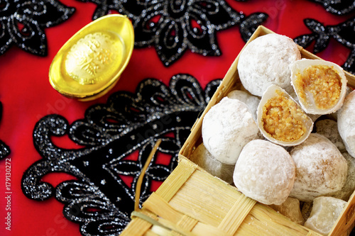 Traditional chinese food called Moci placed in bamboo containers captured from top angle in red background. photo