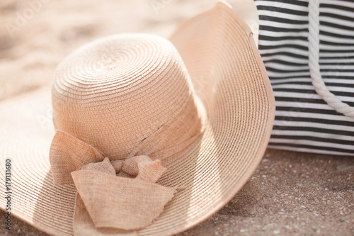 Straw hat, bag on a tropical beach.