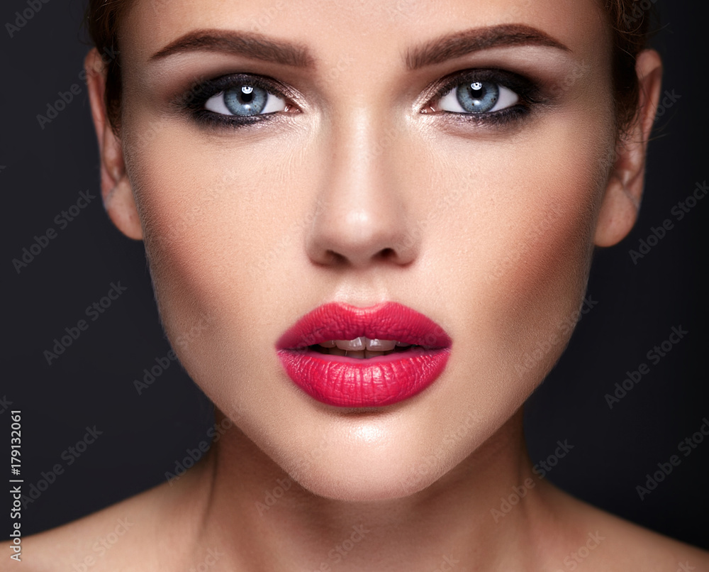 Portrait of beautiful girl model with evening makeup and romantic hairstyle. Red lips Portrait of beautiful girl model with evening makeup and romantic hairstyle. Red lips