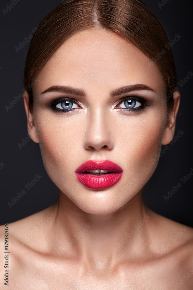 Portrait of beautiful girl model with evening makeup and romantic hairstyle. Red lips Portrait of beautiful girl model with evening makeup and romantic hairstyle. Red lips