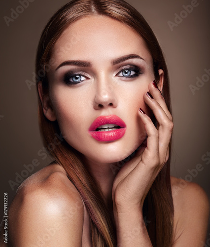 Portrait of beautiful girl model with evening makeup and romantic hairstyle. Red lips