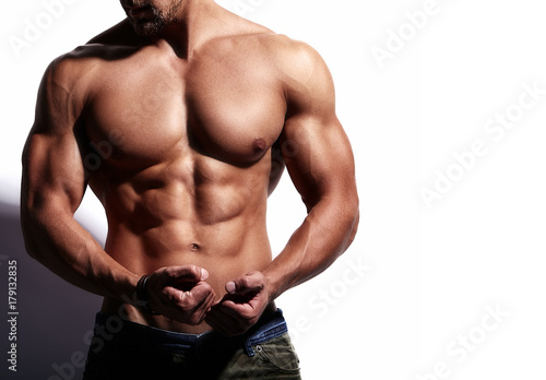 Fotografija Portrait of strong healthy handsome Athletic Man Fitness Model isolated on white