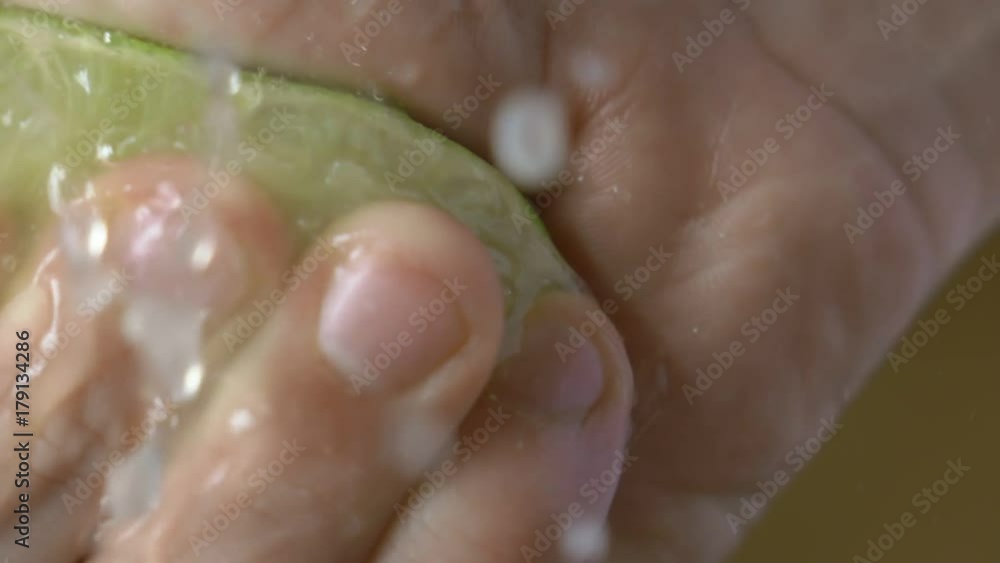 Man hand presses a lime on kitchen Man hand presses a lime on kitchen
