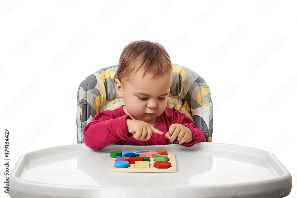 Child little girl learning to use colorful logic game isolated on white background Child little girl learning to use colorful logic game isolated on white background