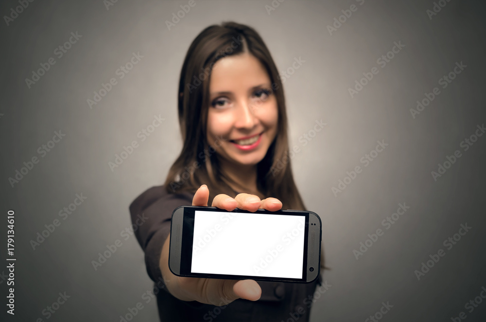 Young blurred happy woman showing mobile phone with blank screen. Contact us concept. Advertisement message. Young blurred happy woman showing mobile phone with blank screen. Contact us concept. Advertisement message.