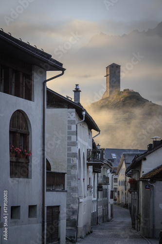 Misty sky on the alpine village of Ardez at sunrise, canton of Graub?nden, district of Inn, lower Engadine photo