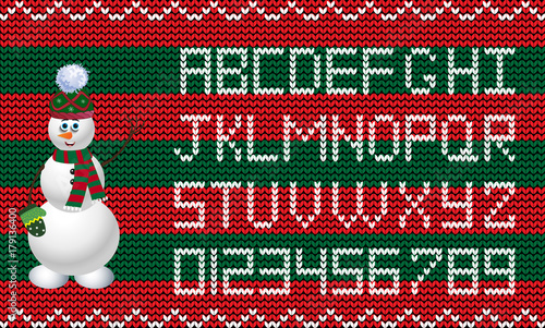 Knit new year and christmas alphabet with snowman character on red and green fabric background