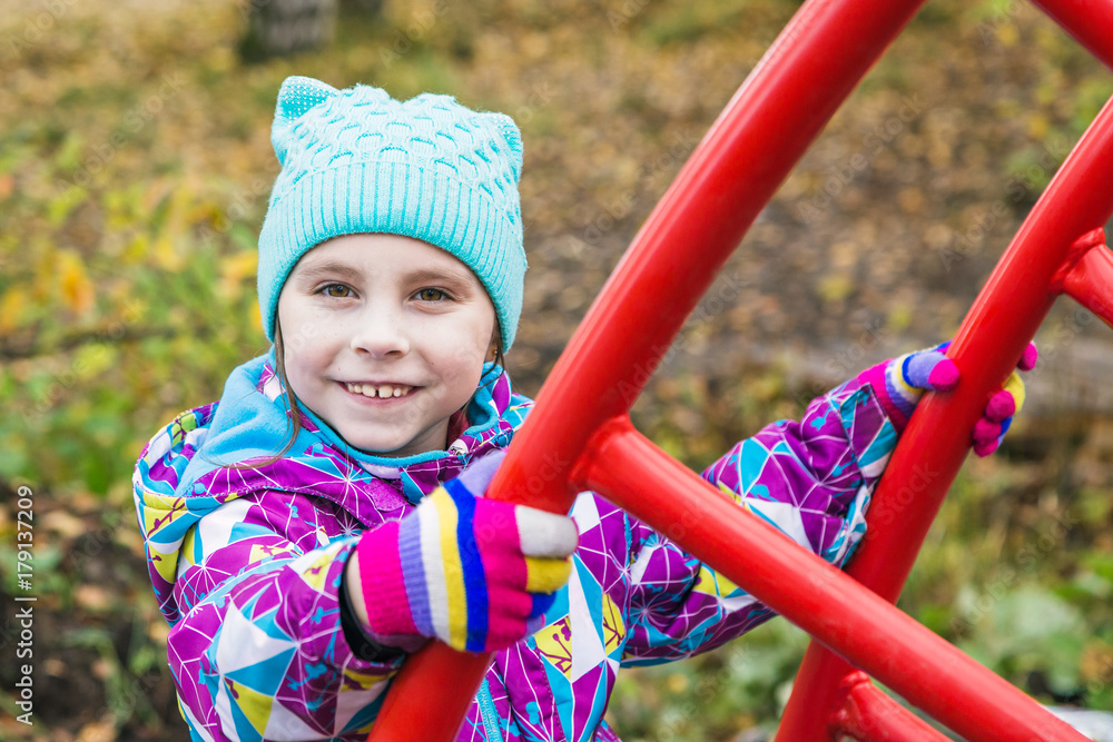 The girl is playing fun on the playground. The girl is playing fun on the playground.