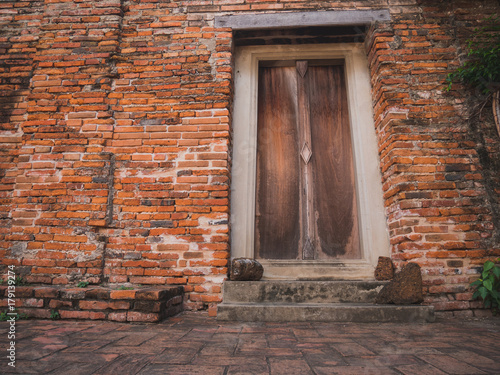 Ancient door and wall of temple (Generality in Thailand,any kind of art decorated in Buddhist church) photo