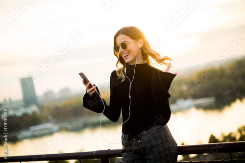 Trendy woman listening musi...