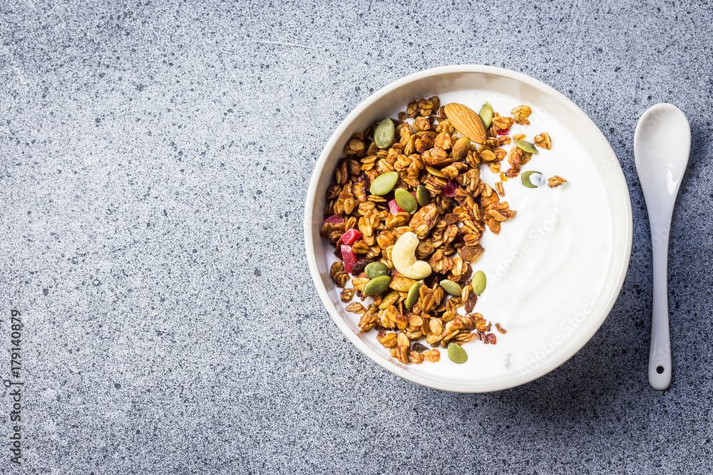 Granola yogurt bowl on dark concrete background. Top view, space for text. Selective focus, copy space. Granola yogurt bowl on dark concrete background. Top view, space for text. Selective focus, copy space.
