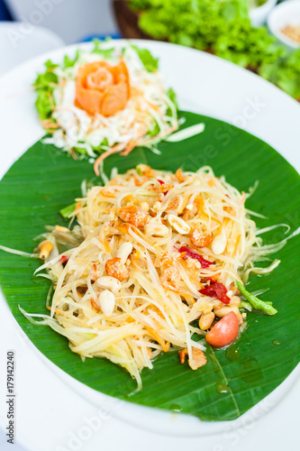 Thai Papaya Salad Serve on Banana Leaf photo