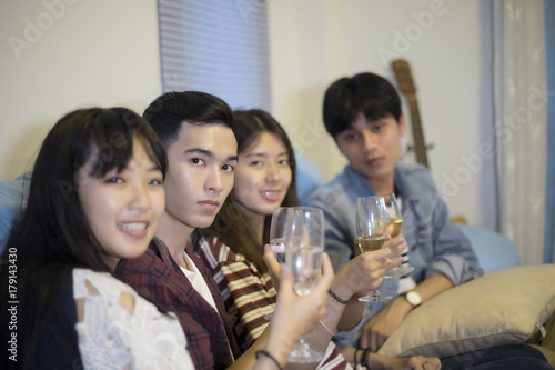 Asian group of friends having party with alcoholic beer drinks and Group people with champagne dancing at party.soft focus