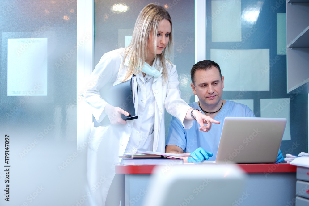Nurse and doctor using laptop in medical clinic. Nurse and doctor using laptop in medical clinic.