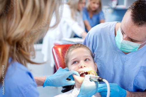 Afraid young girl having check up at dentist's.