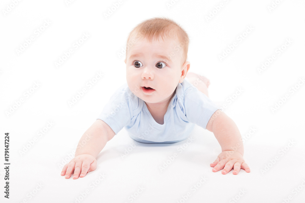 baby in the body lying on his stomach on a white background and looking at the camera baby in the body lying on his stomach on a white background and looking at the camera
