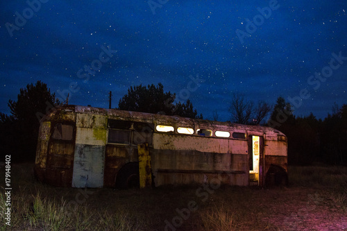 Abandoned bus in Chernobyl area at night time photo