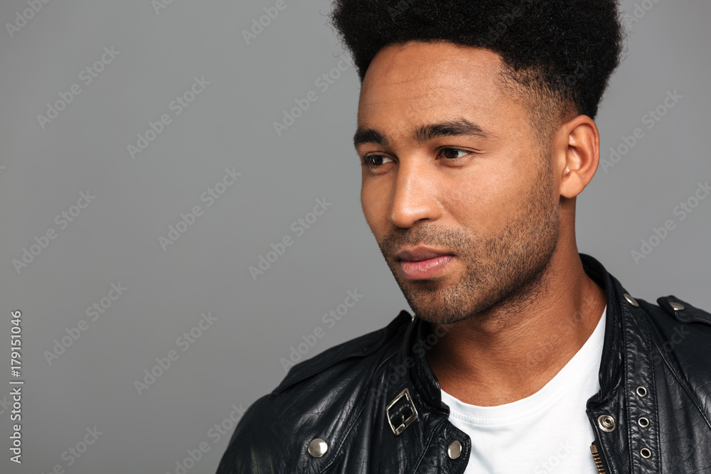 Obraz premium Close-up photo of serious young afro american guy with stylish haircut looking aside