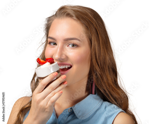 Cute attractive young woman standing and holding cup dessert