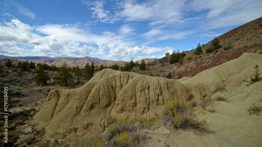 Badlands yellow clay John day fossil beds formations clouds and shadows drift over a remote desert mountain Sutton Mountain close to the Painted hills 7 Badlands yellow clay John day fossil beds formations clouds and shadows drift over a remote desert mountain Sutton Mountain close to the Painted hills 7