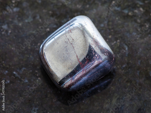 tumbled hematite stone on dark background