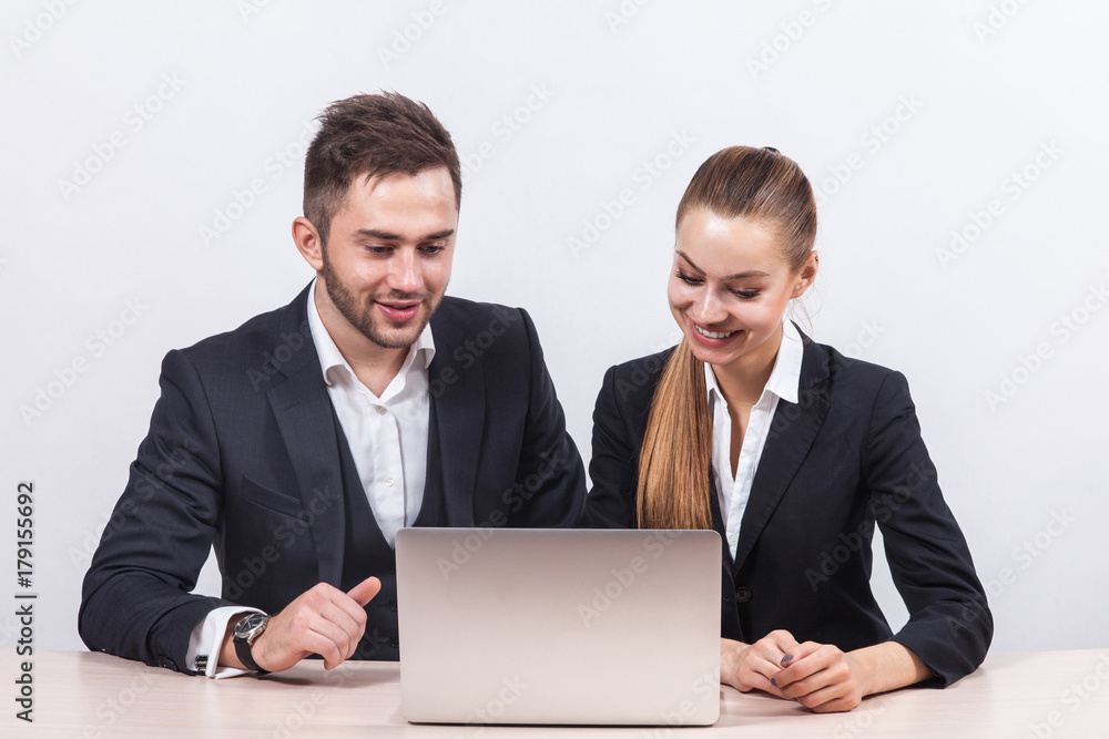 Picture of couple of office workers working together on PC Picture of couple of office workers working together on PC