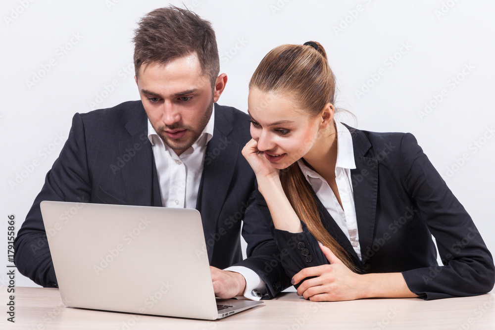 Picture of couple of office workers working together on PC Picture of couple of office workers working together on PC