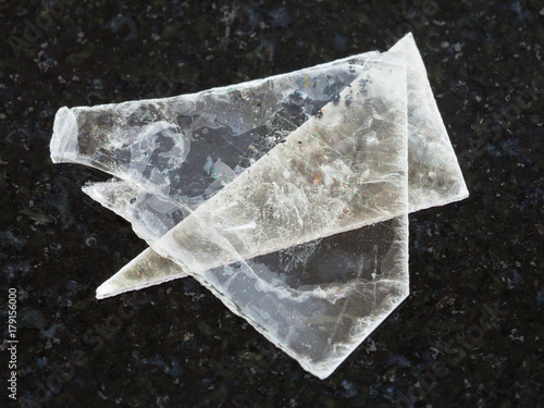 raw muscovite mica lamina on dark background