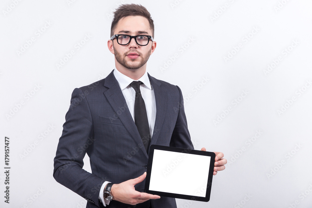 Picture of serious businessman standing with tablet Picture of serious businessman standing with tablet