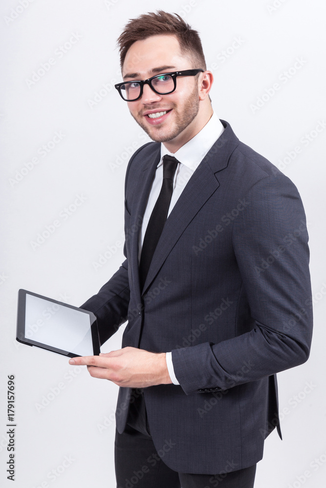 Picture of serious businessman standing with tablet Picture of serious businessman standing with tablet
