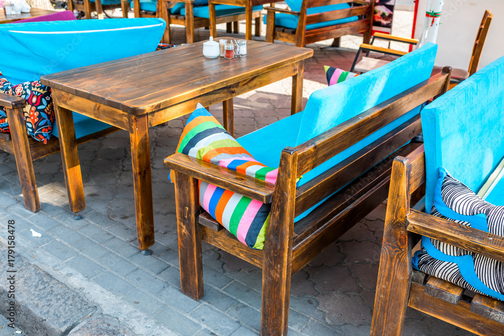 Fototapeta premium outdoor wooden furniture in a cafe on the street