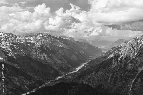 An aerial top black and white view of a river in mountain canyon. Concept of calendar about Caucasus Mountains and Karachai-Cherkess in Russia. Black-and-white greyscale photo with high contrast.