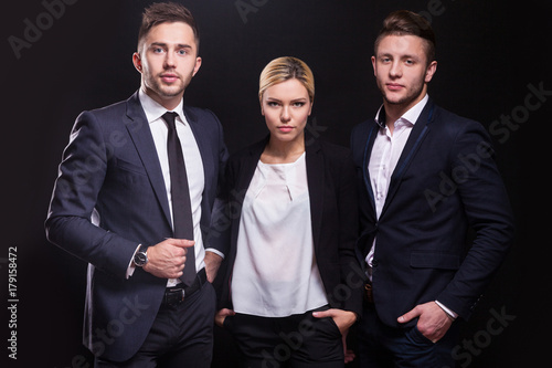 Billede på lærred Picture of young trio of office workers standing