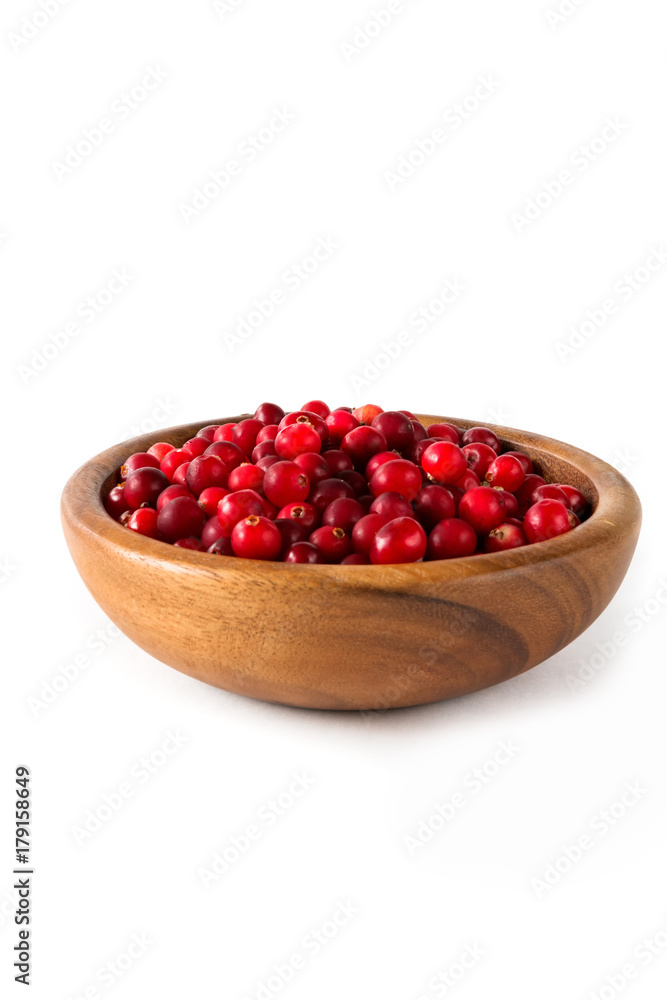 Berries of a cranberry in a wooden bowl on a white background isolate close-up Berries of a cranberry in a wooden bowl on a white background isolate close-up