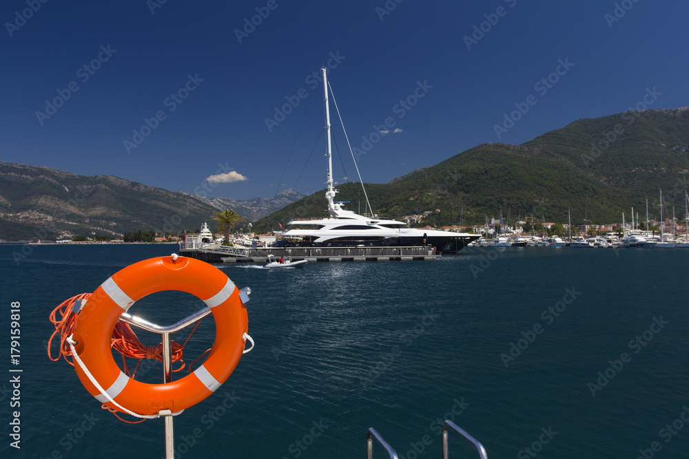 Life buoy ring and luxury yachts in Porto Montenegro, prestigious shopping village and yacht port