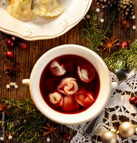 Christmas beetroot soup, borsch with small dumplings with mushroom stuffing, traditional Christmas dish in Poland. Top view