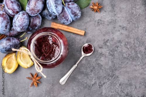 Fototapeta Naklejka Na Ścianę i Meble -  Composition with jar of tasty plum jam on table