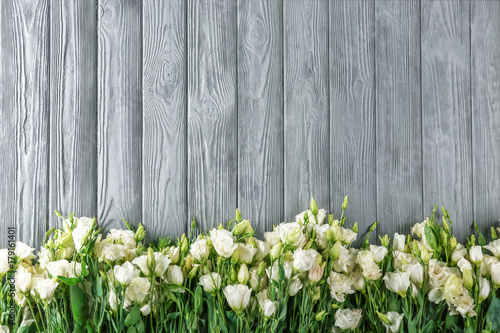 Beautiful eustoma flowers on wooden background